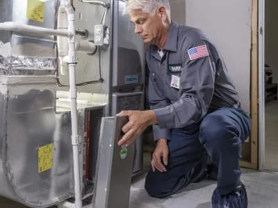 A HARP Home Services doing heating unit maintenance in your home