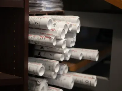 Stacked electrical project plans at Cascade Electric in Tucson, Arizona