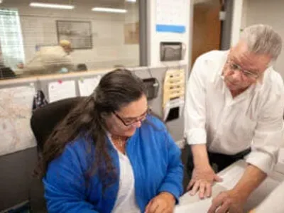 Electricians going over plans in an office
