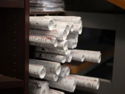 Stacked electrical project plans at Cascade Electric in Tucson, Arizona