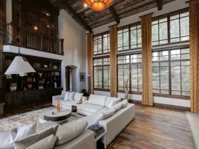 Modern rustic Denver living room with freshly painted white walls, tall windows, and wood accents