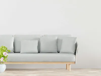 A plant and sofa complement the minimalist flooring.