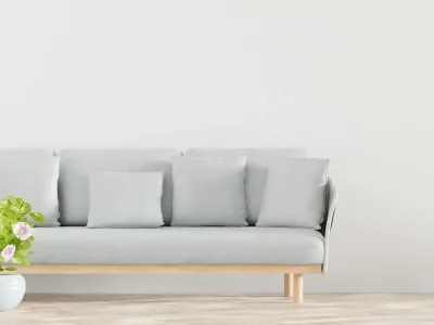 A plant and sofa complement the minimalist flooring.