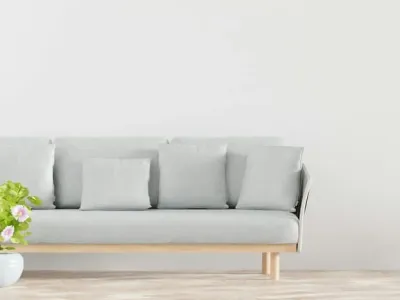 A plant and sofa complement the minimalist flooring.
