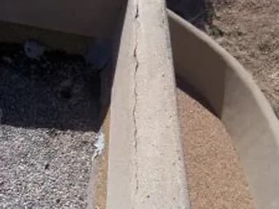 inspecting cracked stucco before repair