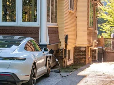 EV charger being installed on a residential house for electric vehicle charging.