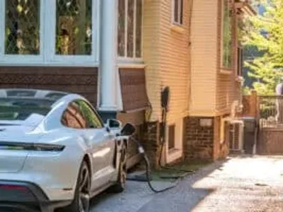 EV charger being installed on a residential house for electric vehicle charging.