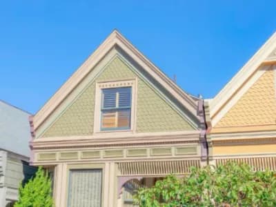 Homes with green, blue, and yellow exteriors