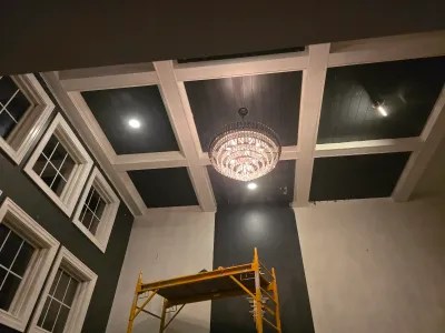 Custom coffered ceiling with painted beams and dark shiplap panels installed by PaintWerks