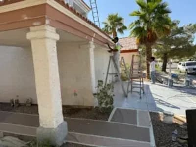 Exterior painting in Las Vegas, NV by Eclipse Painting showing professional painters on ladders refinishing a residential home exterior under the Nevada sun.