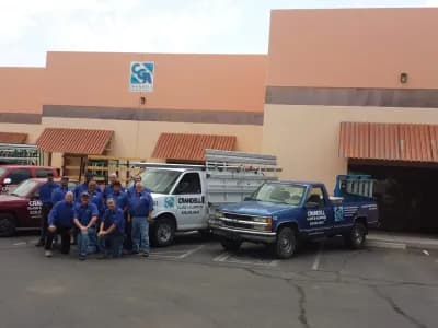 Crandell Glass employees and service trucks outside building
