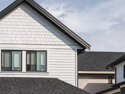 Black roof shingles on a white home