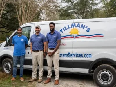 Three Tillman's Services technicians standing in front of a branded service van, showcasing expertise and community commitment in HVAC solutions.