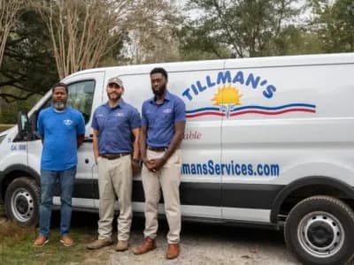 Three Tillman's Services technicians standing in front of a branded service van, showcasing expertise and community commitment in HVAC solutions.