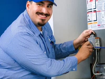Al Coronado plumbing expert working on a water heater installation
