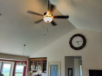 Ceiling fan on tall ceiling.