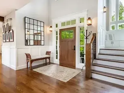 Hardwood floors and clean white walls brighten a foyer finished by Paint‑Pro’s in Ormond Beach.