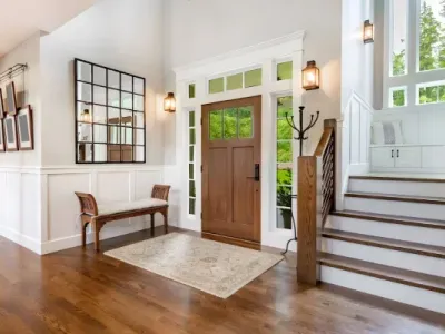 Wood flooring and white walls brighten a foyer updated by Paint‑Pro’s in Ormond Beach.