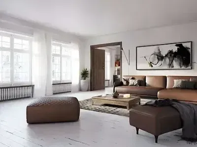 A spacious living room with wood floors and white walls shows detail from Paint‑Pro’s painting services.