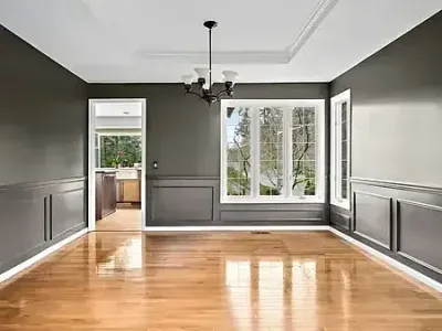 Gray walls and polished hardwood floors add warmth to a room painted by Paint‑Pro’s in Ormond Beach.
