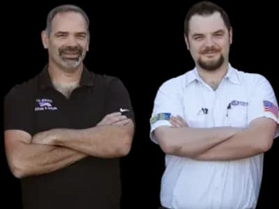Two smiling J.A. Bertsch HVAC technicians, one wearing black and one wearing white.