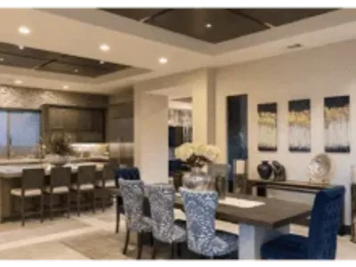 A dining room with blue chairs and a table