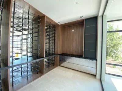 Modern wine cellar with wooden accents and glass racks.