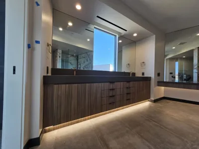 A large bathroom with two sinks and a mirror.