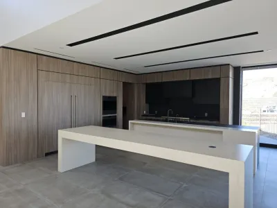 A large kitchen with a big table and some cabinets