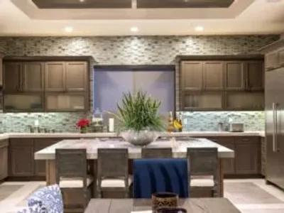 A kitchen with a table and chairs in it