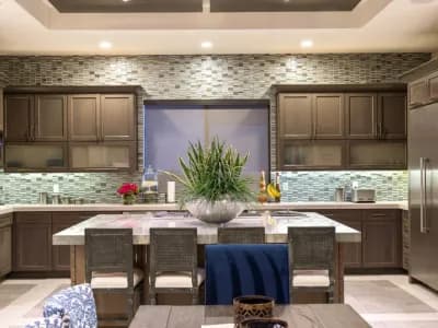 A kitchen with a table and chairs in it