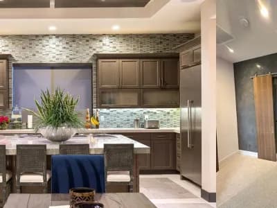 A kitchen with a table and chairs, and a refrigerator.