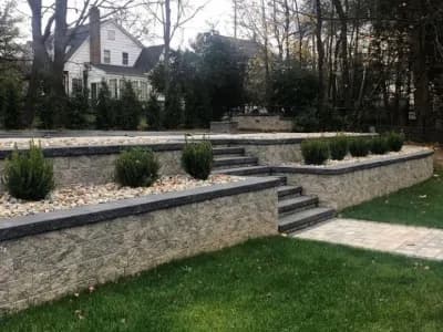 Tiered retaining wall hardscape with steps and landscaping in Old Tappan, Bergen County, NJ, by Masonry Pro Construction