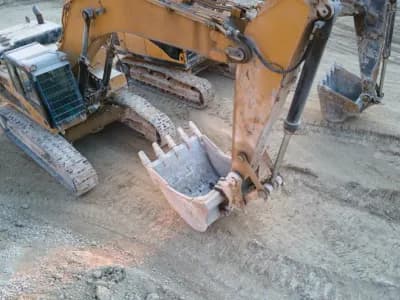 Excavator finishing a limestone slab.