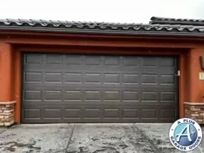 Dark brown insulated Amarr garage door installation in Ivins, Utah