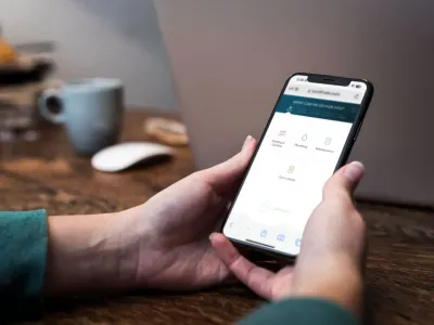 person holding a phone with scheduling buttons