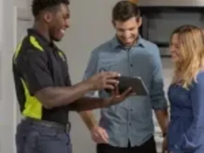 HVAC tech showing tablet to customers