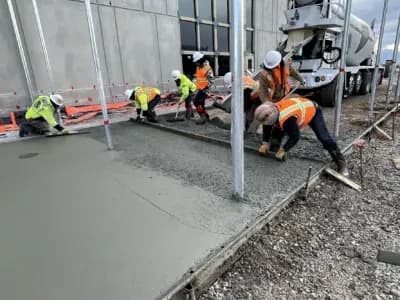 MC Green employees leveling cement, paving