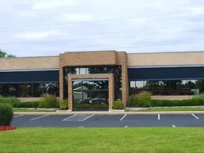 Single-story office building with parking lot.