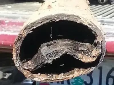 A piece of orangeburg pipe that failed underground and had to be removed.