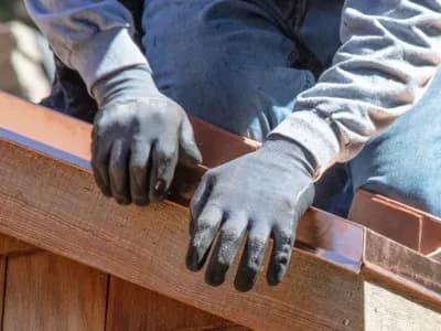 Worker fixes flashing as part of home inspection repairs