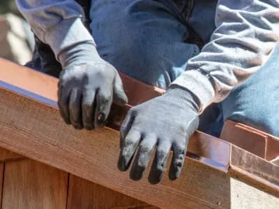 Worker fixes flashing as part of home inspection repairs